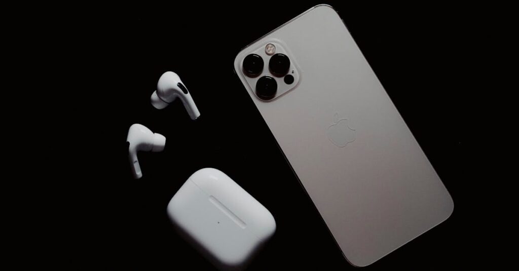 Close-up of smartphone and wireless earbuds on a dark surface, showcasing modern tech gadgets.