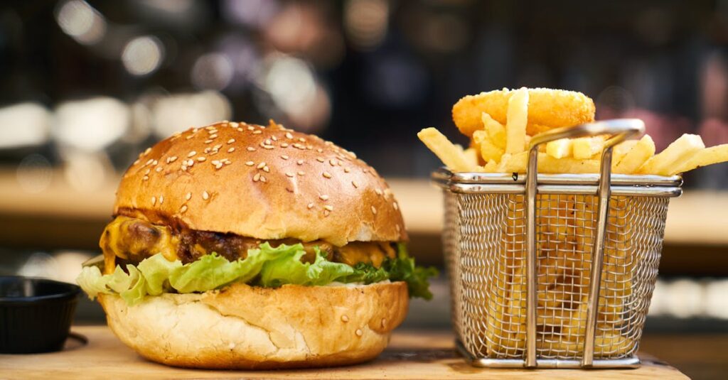 A delicious cheeseburger with crispy french fries served on a wooden platter, perfect for lunch or dinner.