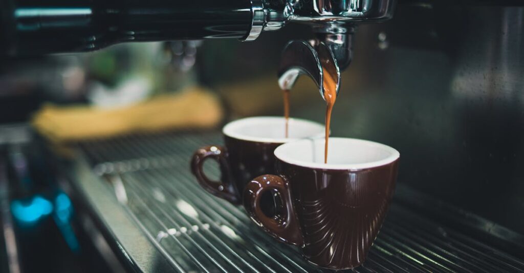 Close-up of a professional espresso machine brewing coffee into cups.