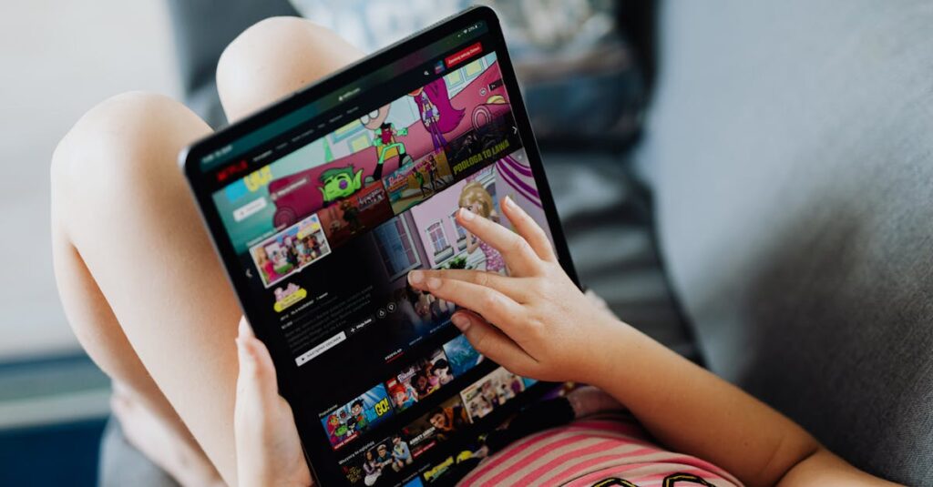 A child using a tablet for streaming cartoons, relaxing on a couch indoors.