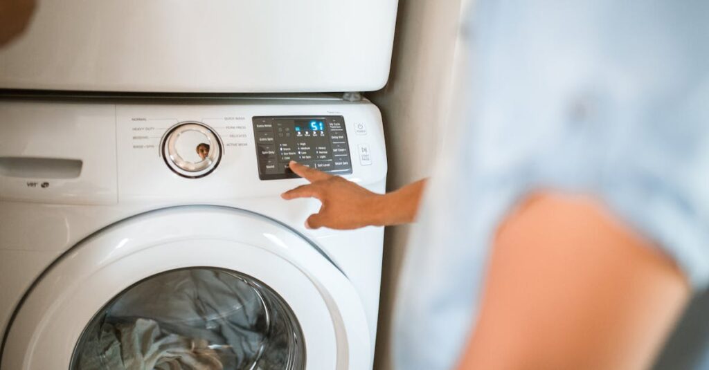 Hand selecting laundry options on a digital washing machine control panel indoors.